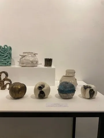 Ceramics arranged on shelves and a table at the Locksbrook exhibition.