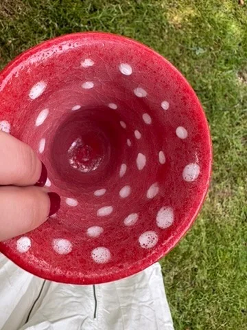 Top view of the Fly Agaric vessel, showing white spots across its bright red interior.