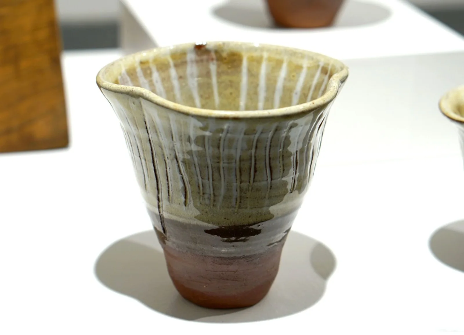 Fungi Vessel I, with a flared ridged rim, pale glaze and warm brown base.