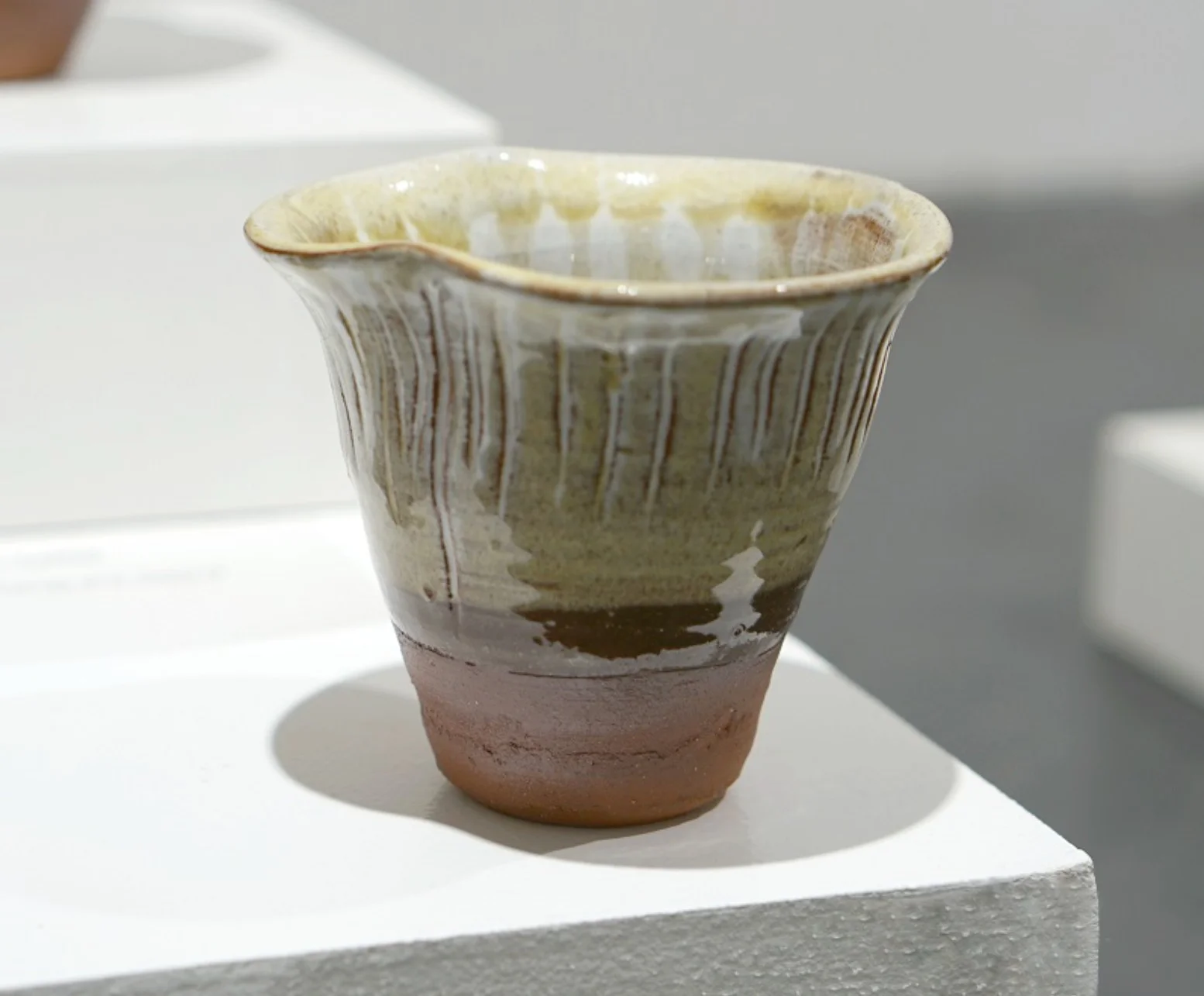 Fungi Vessel III, with a flared ridged rim, pale glaze and warm brown base.