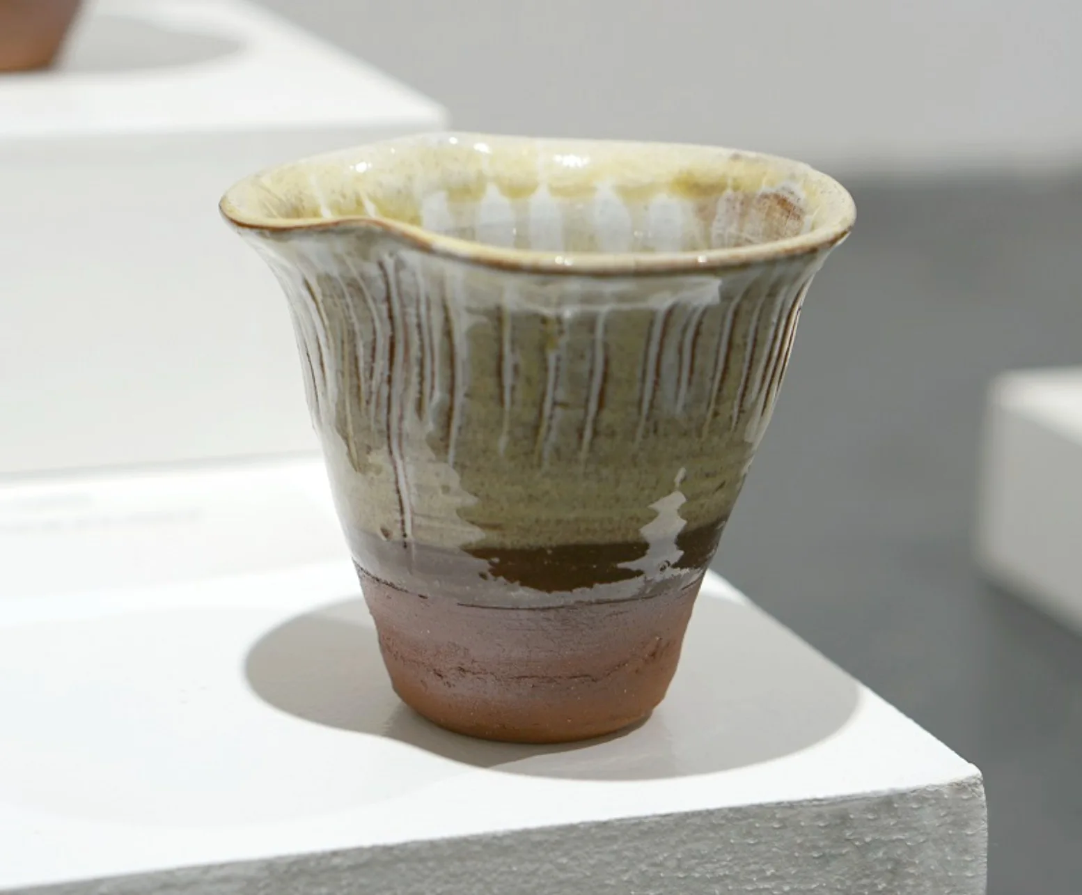 Fungi Vessel III, with a flared ridged rim, pale glaze and warm brown base.