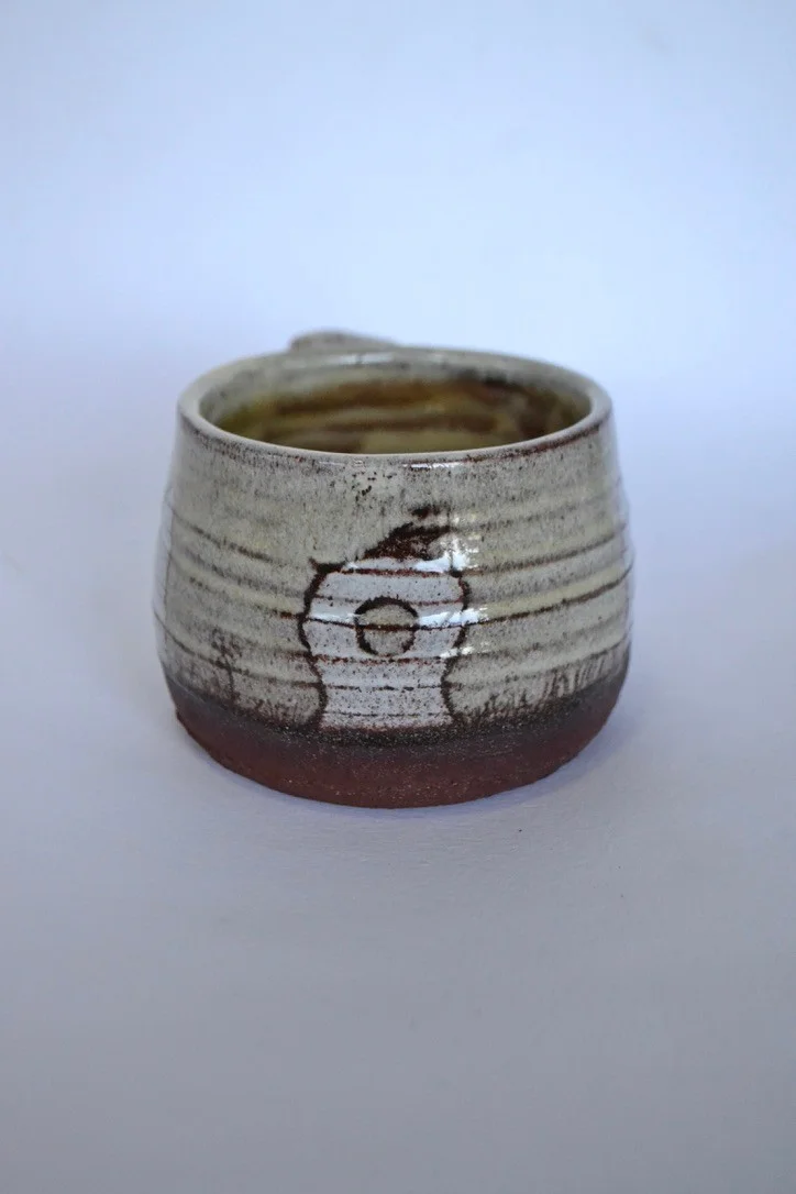 Grey Mên an Tol mug with a circular opening drawn into the central stone.