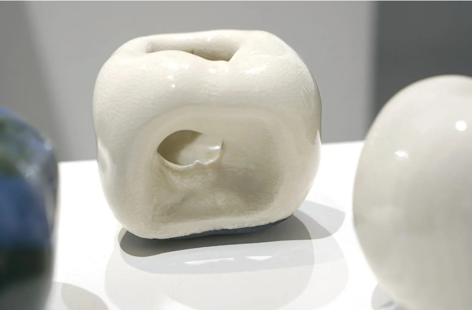 White porcelain apple with an open, hollow centre.