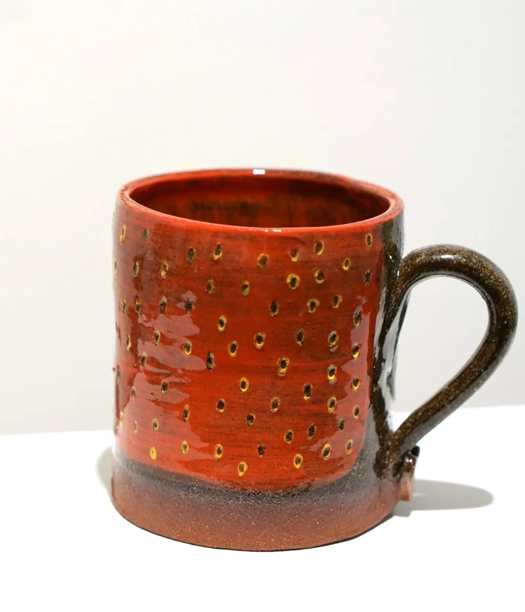 Red strawberry mug on display.