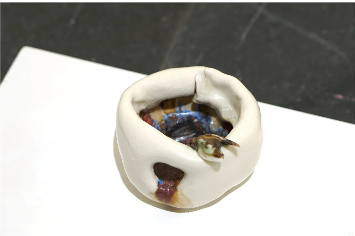 Broken porcelain apple form viewed from above.