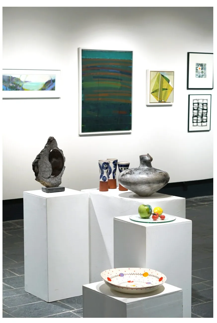Porcelain fruit on plinths within the wider exhibition.