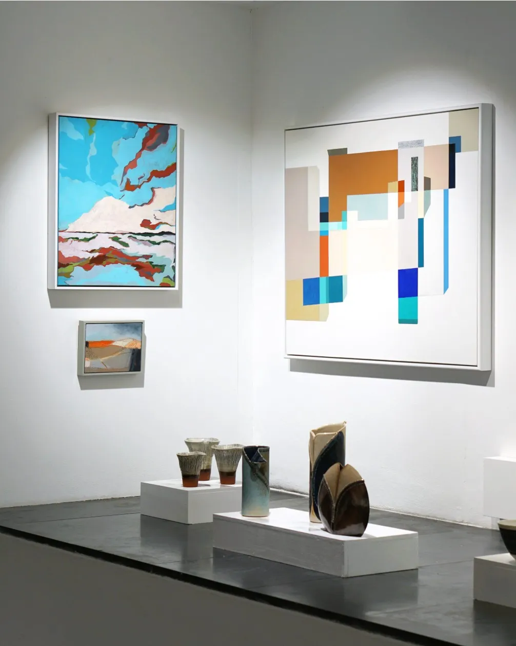 Wider gallery view with fungi vessels on a plinth among other artists’ work.