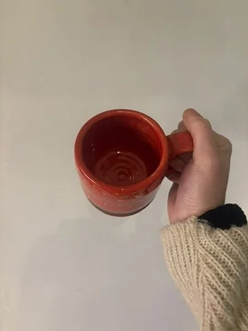 Strawberry mug viewed from above, showing its glazed interior and curved handle.